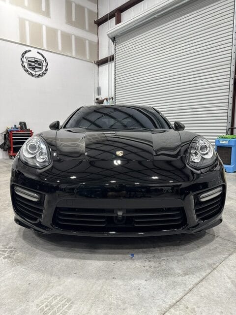 Aerial view of a car detailing setup, showcasing tools and products for vehicle care.