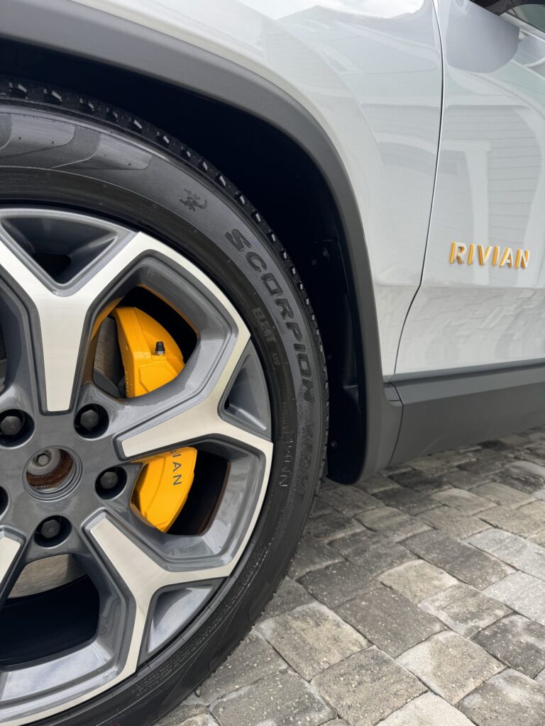 mobile detailing service Jacksonville FL - A detailed view of a shiny car exterior reflecting sunlight, showcasing the qualit