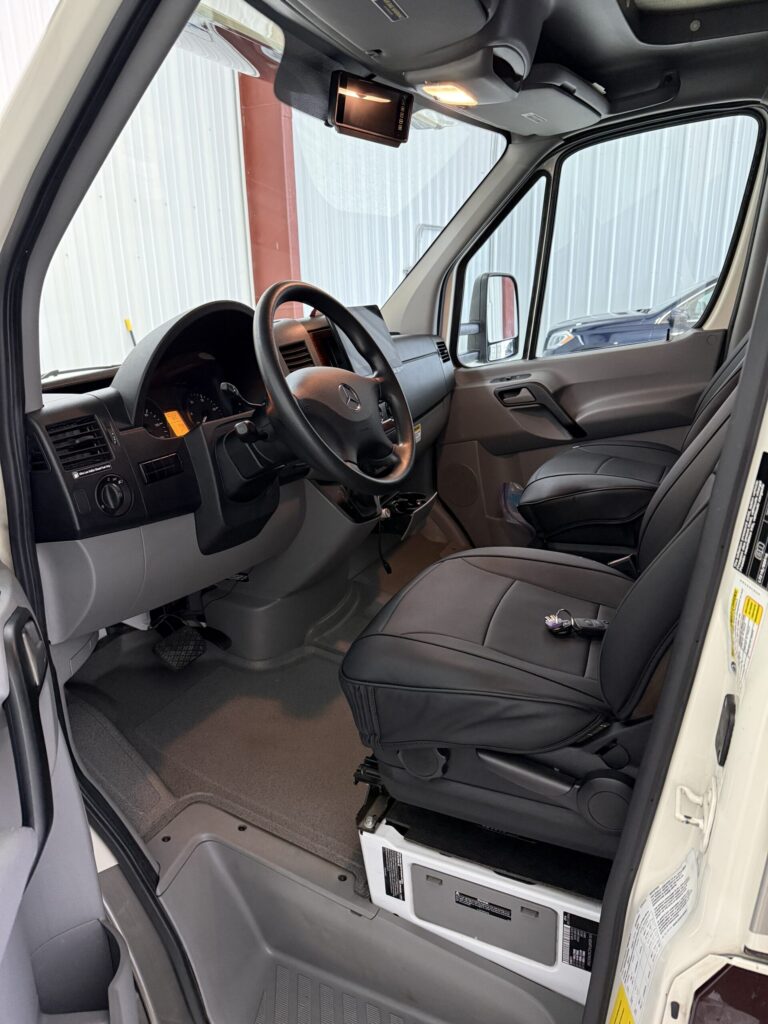 A clean, shiny car parked in a well-lit garage, showcasing the results of mobile detailing service Jacksonville FL.