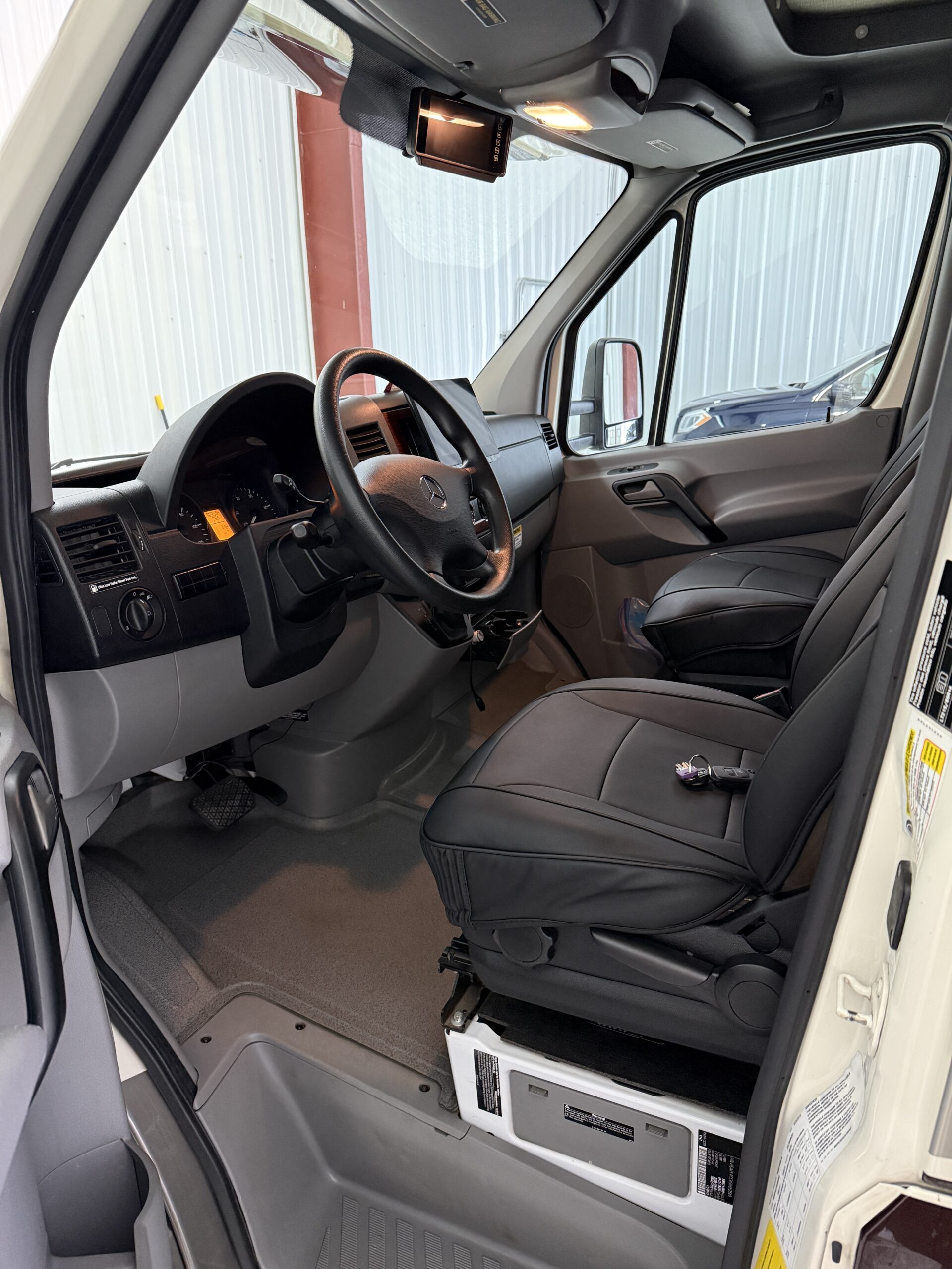 A clean, shiny car parked in a well-lit garage, showcasing the results of mobile detailing service Jacksonville FL.