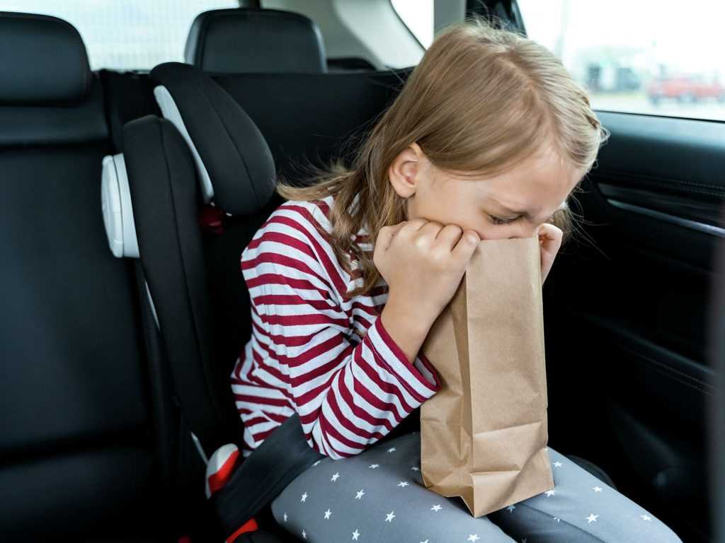 A stained car seat with vomit residue, illustrating how to clean vomit from car upholstery effectively.