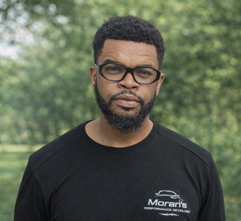 premium detailing Jacksonville FL - Kevin Moran, founder of Moran's Performance Detailing, stands confidently in front of a d