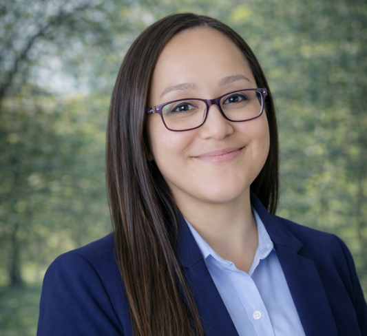 Sandy smiling in front of a car, showcasing premium detailing Jacksonville FL expertise.