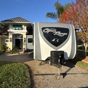 A detailed view of a polished car surface reflecting light, showcasing the quality of the detailing work.