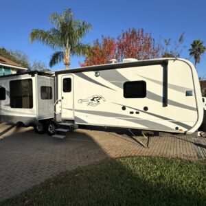 A detailed view of a shiny car exterior reflecting light, showcasing the quality of Moran's Performance Detailing services.