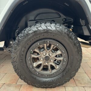 A detailed view of a shiny, well-polished car hood reflecting the surrounding environment.