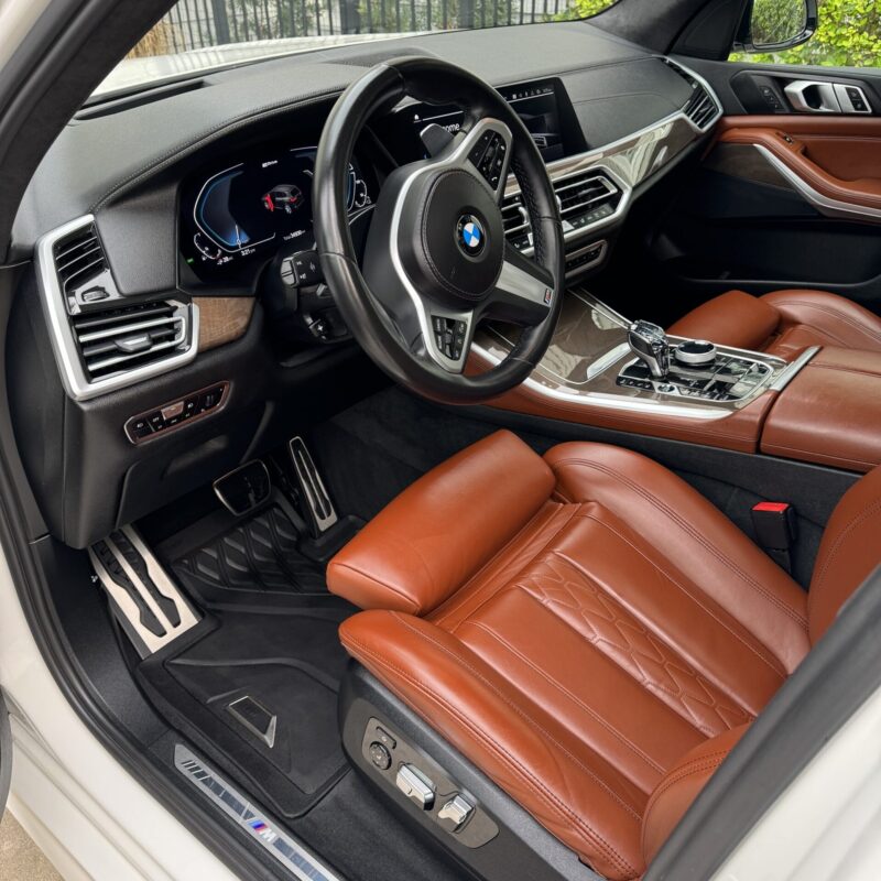 A close-up of a shiny car hood reflecting light, showcasing the high-quality detailing services at Moran's Performance Detail