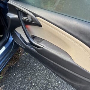 A detailed view of a shiny black car hood reflecting light, showcasing Moran's Performance Detailing expertise.