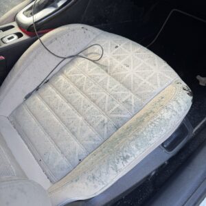 A detailed view of a polished car surface showcasing a high-gloss finish and reflections, emphasizing quality detailing.