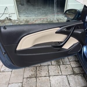 A detailed view of a polished car hood reflecting light, showcasing the shine and clarity of the surface.