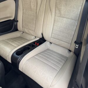 A close-up view of a polished car surface reflecting light, showcasing the detailing work done at Moran's Performance Detaili