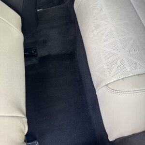 A close-up of a shiny car hood reflecting light, showcasing a detailed car detailing service.