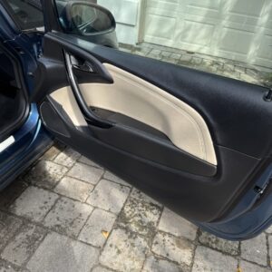 A detailed view of a shiny car surface reflecting light, showcasing the quality of Moran's Performance Detailing.