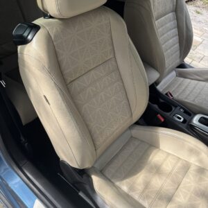 A close-up of a polished car hood reflecting natural light, showcasing a high-quality detailing finish.
