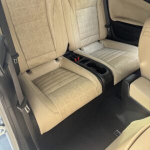 A close-up view of a shiny car surface reflecting light, showcasing the detailing work done at Moran's Performance Detailing.