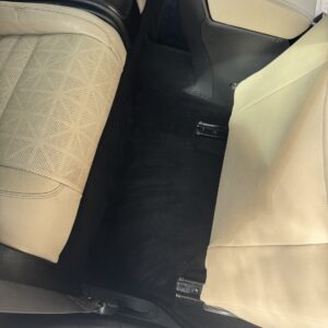 A detailed view of a polished car surface reflecting light, showcasing the quality of Moran's Performance Detailing services.