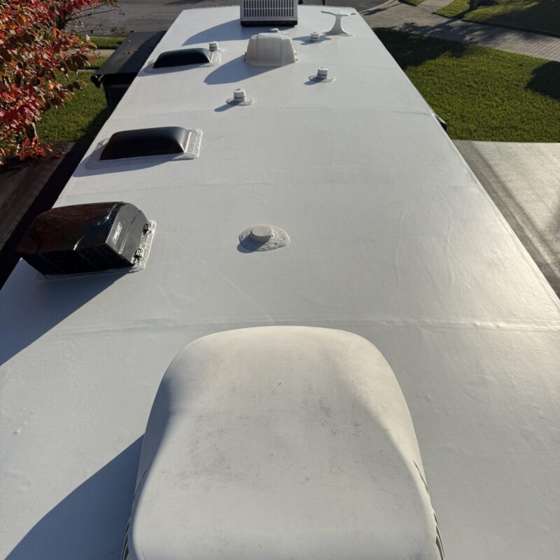 A detailed view of a shiny car hood showcasing a flawless paint finish, highlighting Moran's Performance Detailing services.