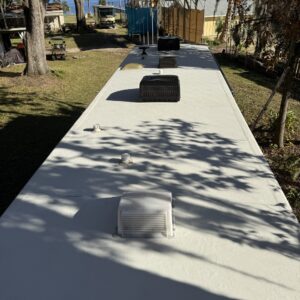 A detailed view of a polished car surface, showcasing a high-gloss finish and reflections, emphasizing the quality of detaili