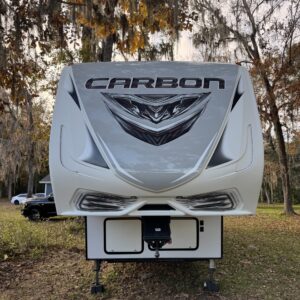 A close-up view of a shiny, detailed car hood reflecting light, showcasing Moran's Performance Detailing services.