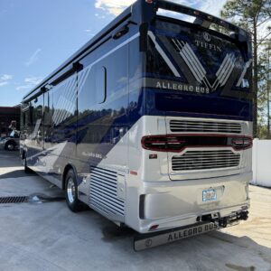 A detailed view of a shiny, well-polished car hood reflecting light, showcasing Moran's Performance Detailing services.