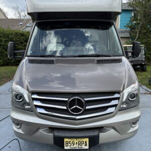 A detailed view of a shiny car hood reflecting light, showcasing the high-quality detailing work at Moran's Performance Detai