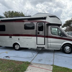 A detailed view of a car's shiny surface reflecting light, showcasing professional detailing work.