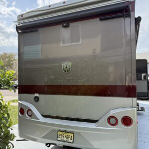 A close-up of a shiny car hood reflecting light, showcasing the detailing work at Moran's Performance Detailing.