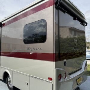 A close-up of a detailed car exterior showing shiny paintwork, reflecting light, showcasing Moran's Performance Detailing exp