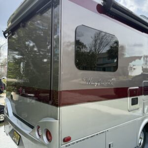 A detailed view of a shiny car hood reflecting light, showcasing the quality of Moran's Performance Detailing services.