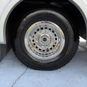 A close-up view of a shiny, polished car surface reflecting light, showcasing the detailing work at Moran's Performance Detai