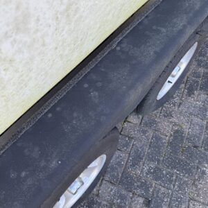 A detailed view of a polished car exterior showcasing a glossy finish, emphasizing Moran's Performance Detailing services.