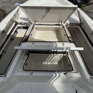 A close-up of a shiny car hood reflecting light, showcasing a detailed paint job and smooth surface.