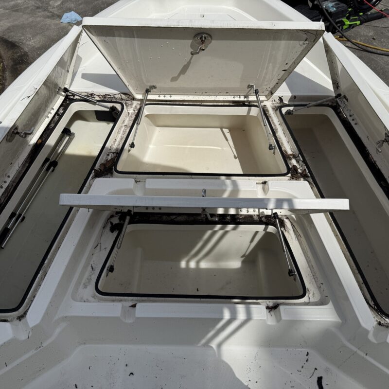 A close-up of a shiny car hood reflecting light, showcasing a detailed paint job and smooth surface.