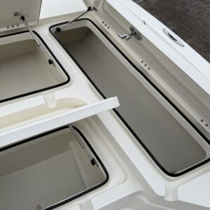 A close-up of a shiny car surface reflecting light, showcasing detailed paintwork and a polished finish.