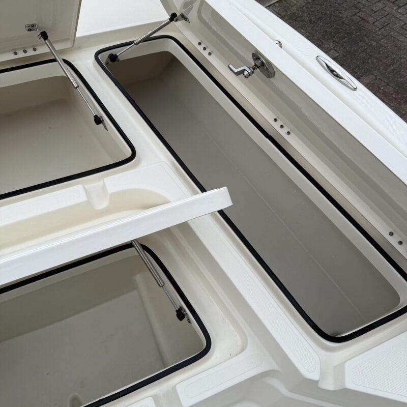 A close-up of a shiny car surface reflecting light, showcasing detailed paintwork and a polished finish.