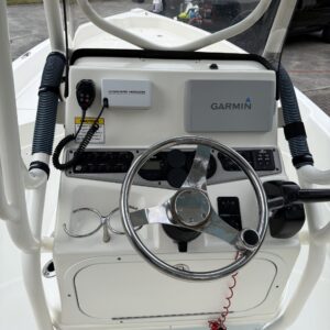 A detailed view of a shiny black car's hood reflecting light, showcasing a professional detailing finish.