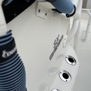 A close-up of a polished car hood reflecting light, showcasing the detailing work at Moran's Performance Detailing.