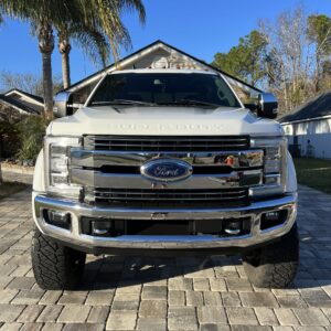 A detailed view of a car's shiny surface reflecting light, showcasing the results of professional detailing.