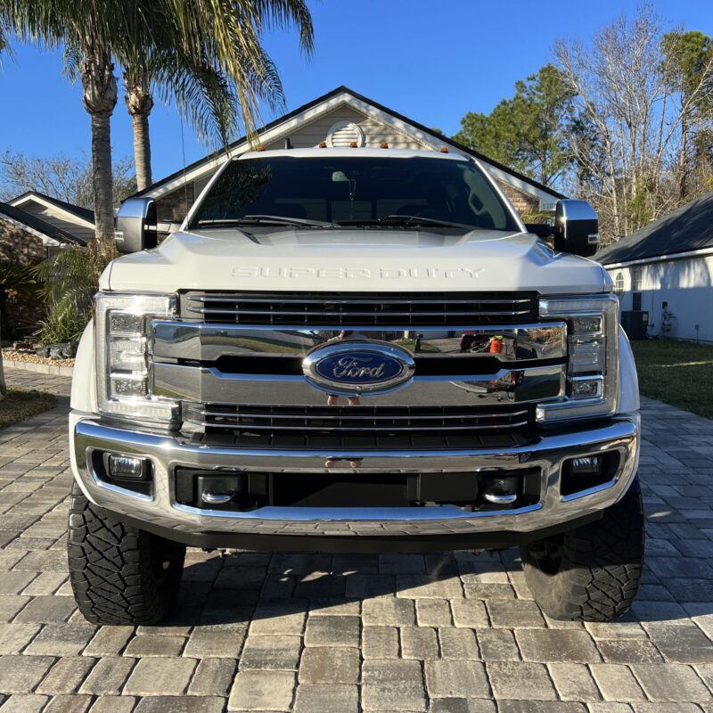 A detailed view of a car's shiny surface reflecting light, showcasing the results of professional detailing.
