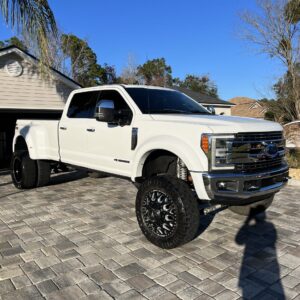 A detailed view of a shiny car hood reflecting light, showcasing a professional detailing job.