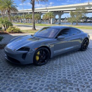 A detailed view of a polished car hood reflecting light, showcasing the quality of Moran's Performance Detailing services.