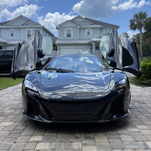 A detailed view of a car's shiny surface reflecting light, showcasing the quality of Moran's Performance Detailing services.