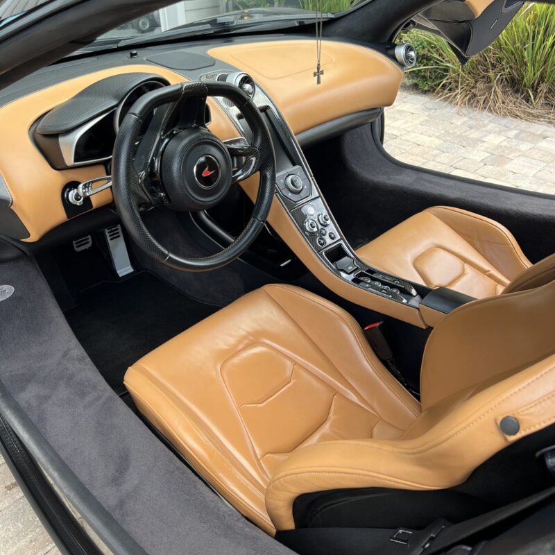 A close-up of a shiny, well-polished car hood reflecting the surrounding environment.