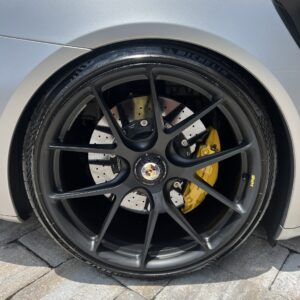 A shiny, detailed car exterior showcasing a professional detailing job, emphasizing the quality of Moran's Performance Detail