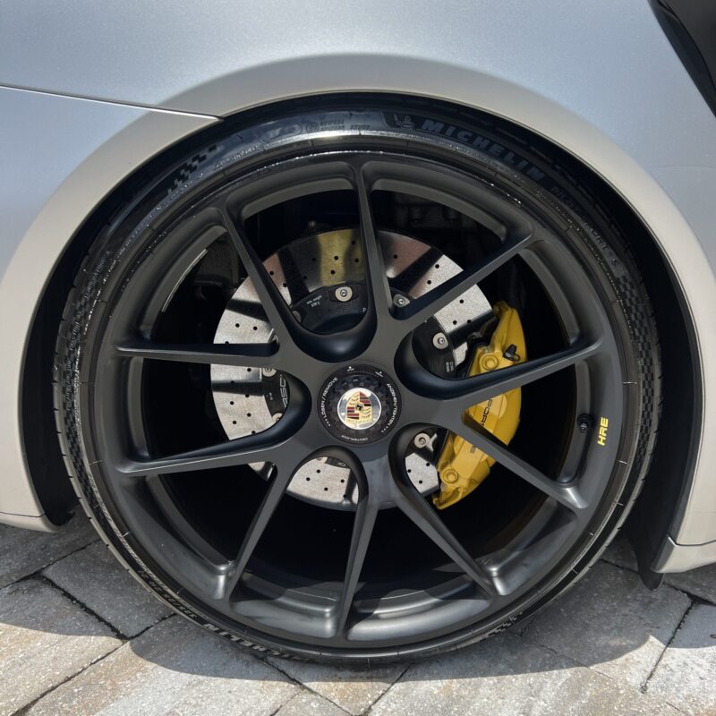 A shiny, detailed car exterior showcasing a professional detailing job, emphasizing the quality of Moran's Performance Detail