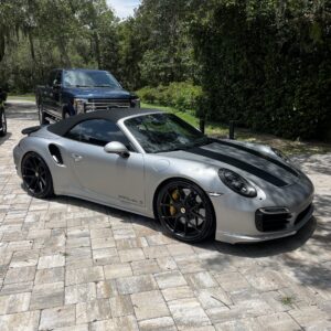 A detailed view of a shiny car exterior after a professional detailing service, showcasing the reflective surface.