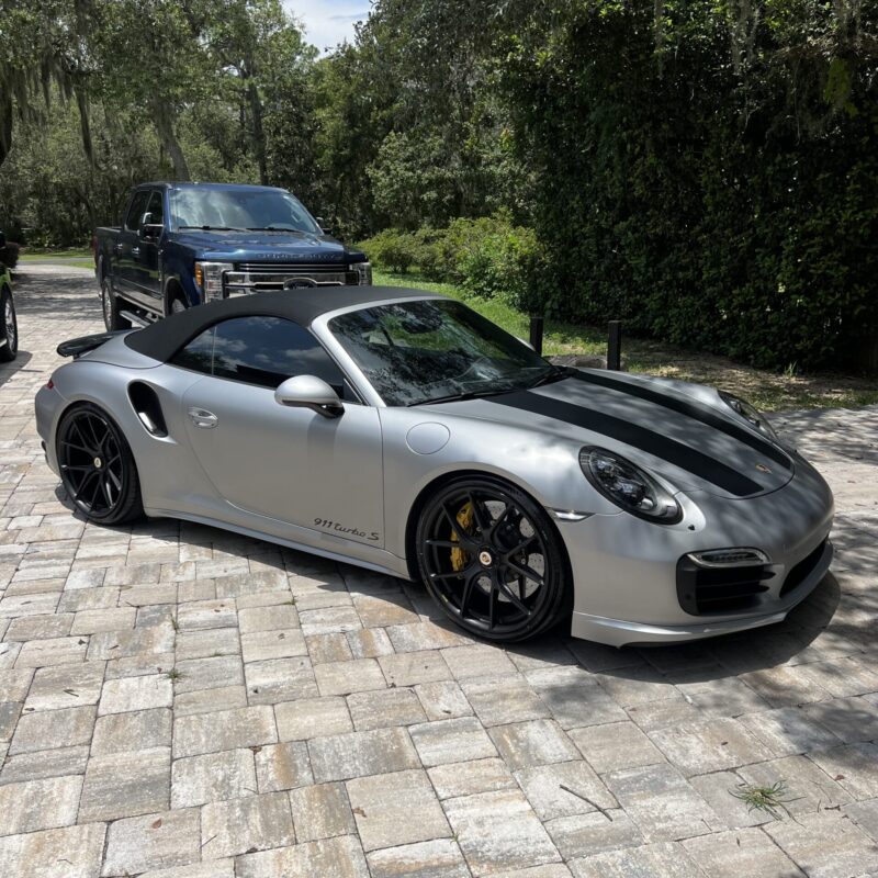 A detailed view of a shiny car exterior after a professional detailing service, showcasing the reflective surface.